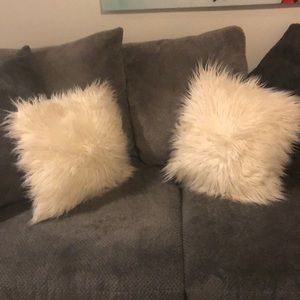 Two white fluffy throw pillows
